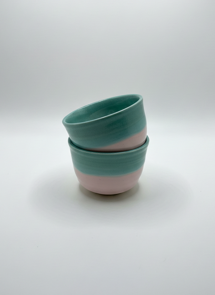 Two ceramic bowls stacked on a white background