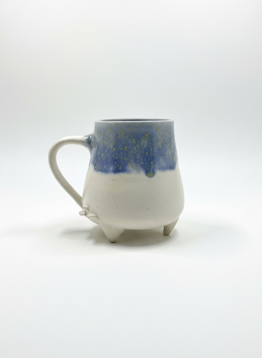 Ceramic mug with blue and white design on a white background