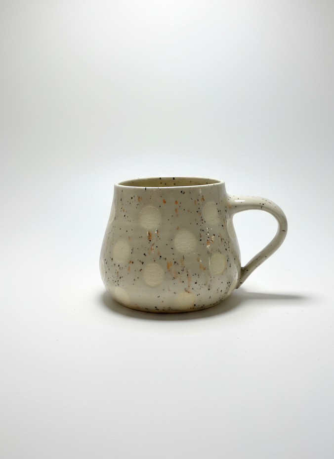 Speckled ceramic mug on a white background