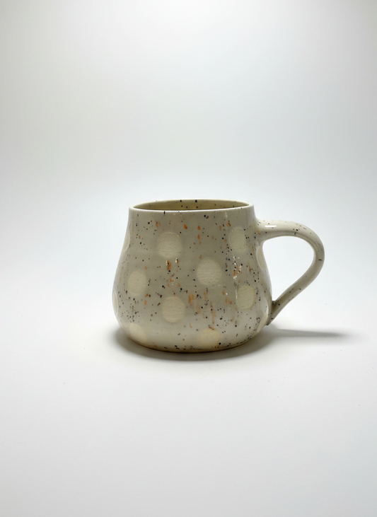 Speckled ceramic mug on a white background