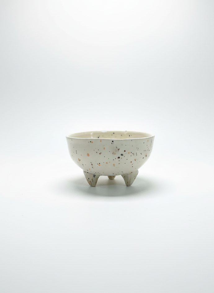Small ceramic bowl with a textured surface on a white background