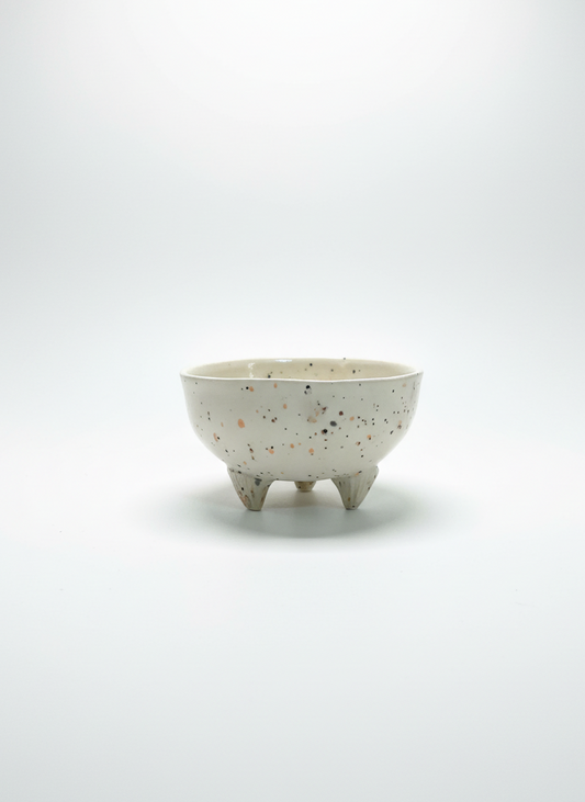 Small ceramic bowl with a textured surface on a white background