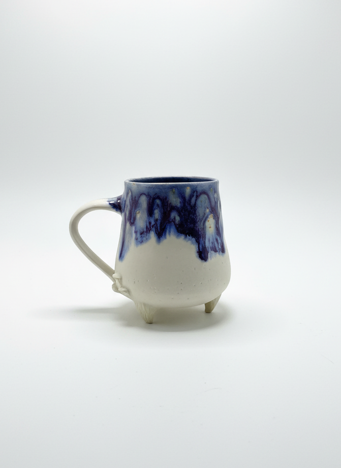 Ceramic mug with blue and white design on a white background