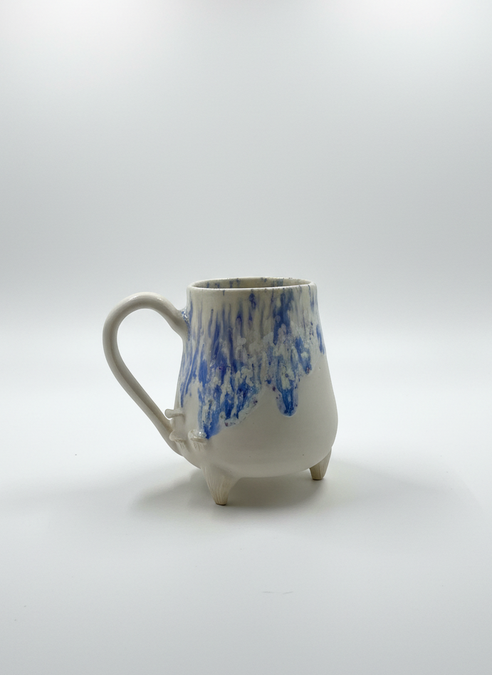 Ceramic mug with blue abstract design on a white background