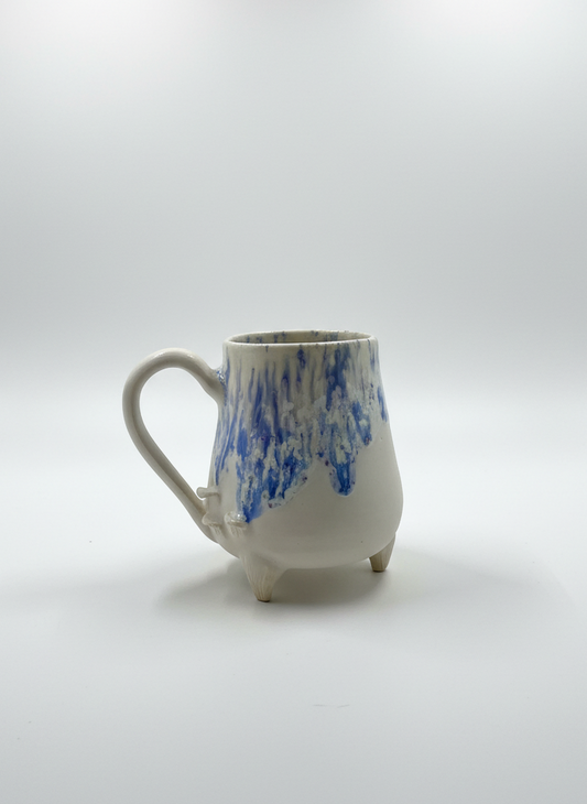 Ceramic mug with blue abstract design on a white background